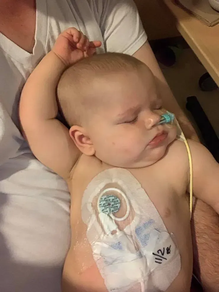 Jazmine sleeping soundly against her dad's chest.